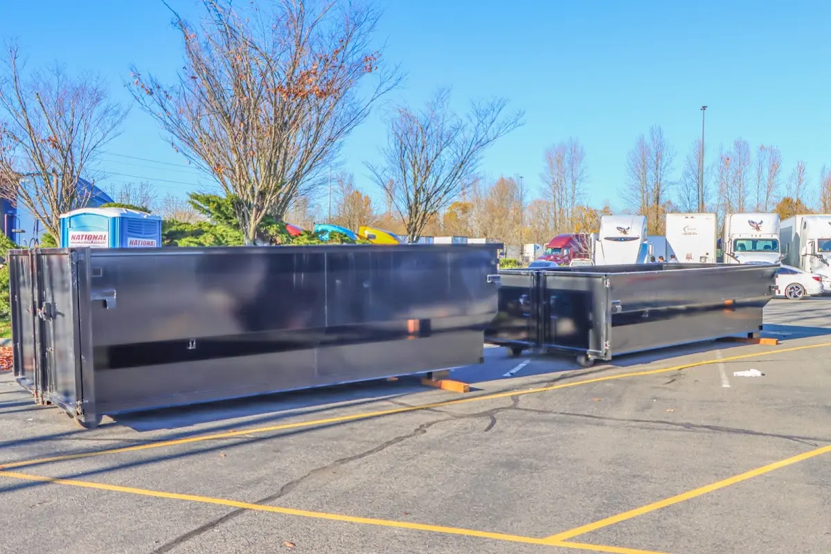 Professional dumpster rental service with roll-off container on residential driveway in Liberty Hill